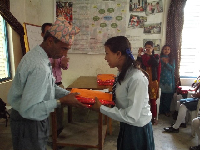 Rukmini Scholars accept their new school materials.