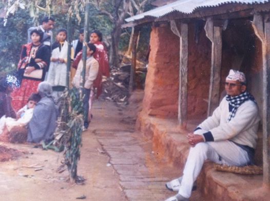 My Father sitting in front on our old family home
