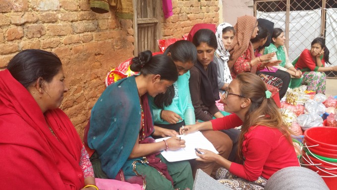 Rukmini Foundation’s mentor Pramila collecting names of families receiving the relief goods.