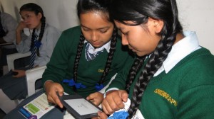 students-checking-out-new-library Students using eBook readers to check out their new library.