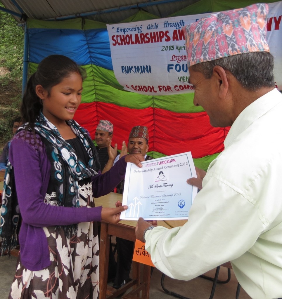 Sweta, who made the wonderful poster of the logo with new scholars' names receives her scholarship.