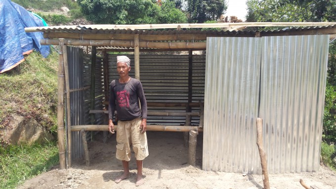 4 father of anju theeng_standing in front of temp shed_simpani