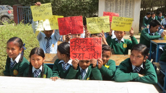 Attendants of the program holding up signs of empowerment. 