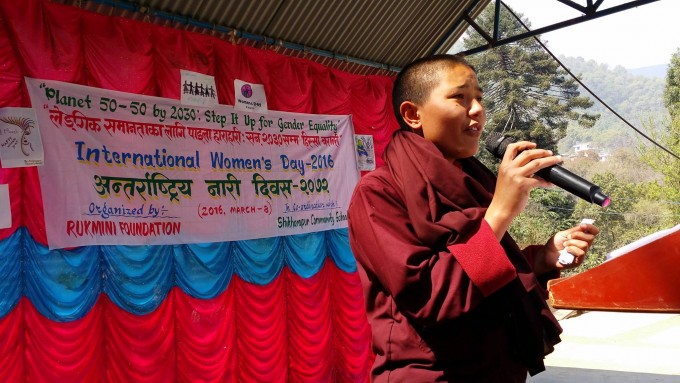 Program participant recites a poem on stage. 