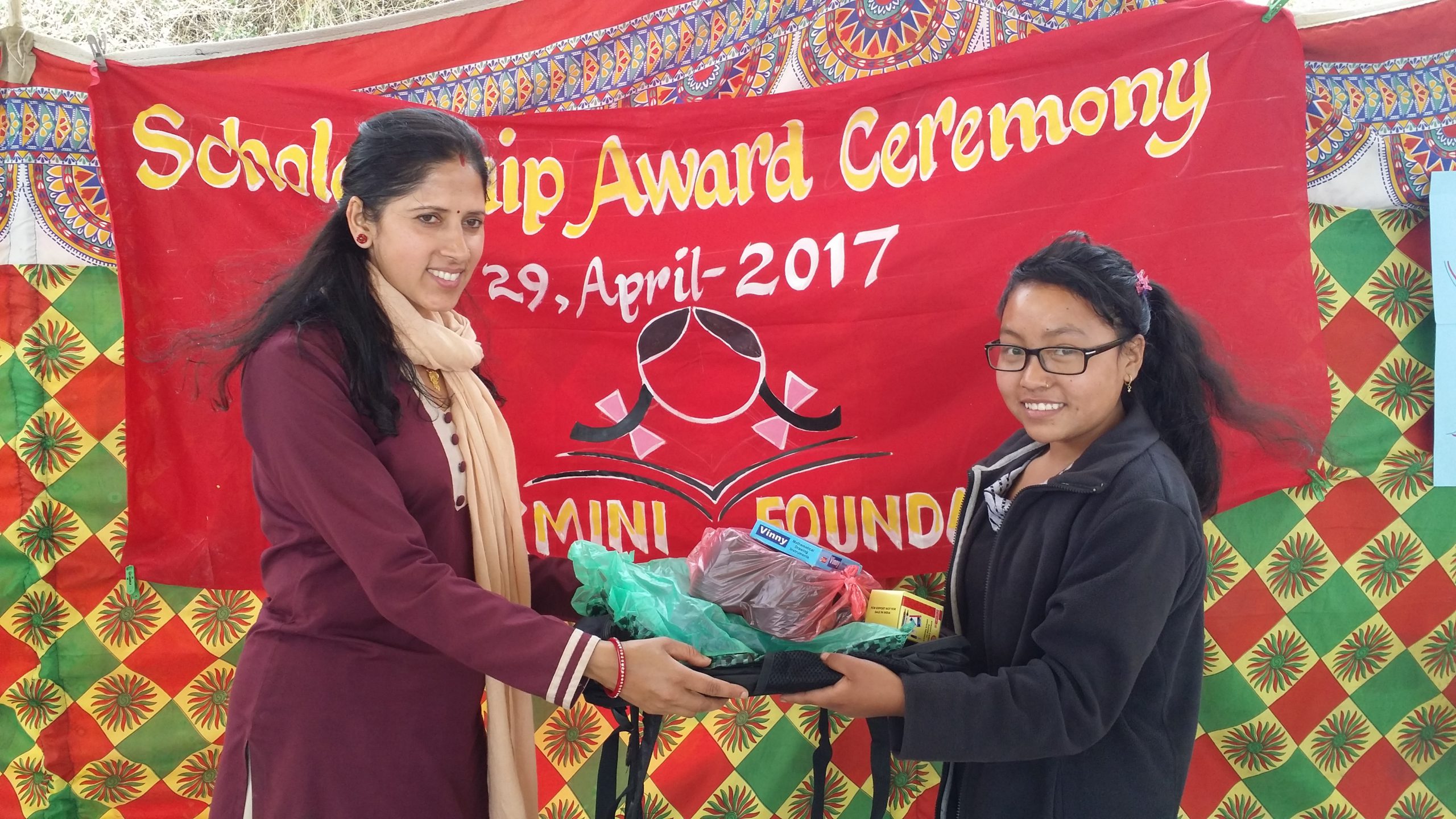 Usha jee distributing bag and dress to new scholars Roshani Rumba