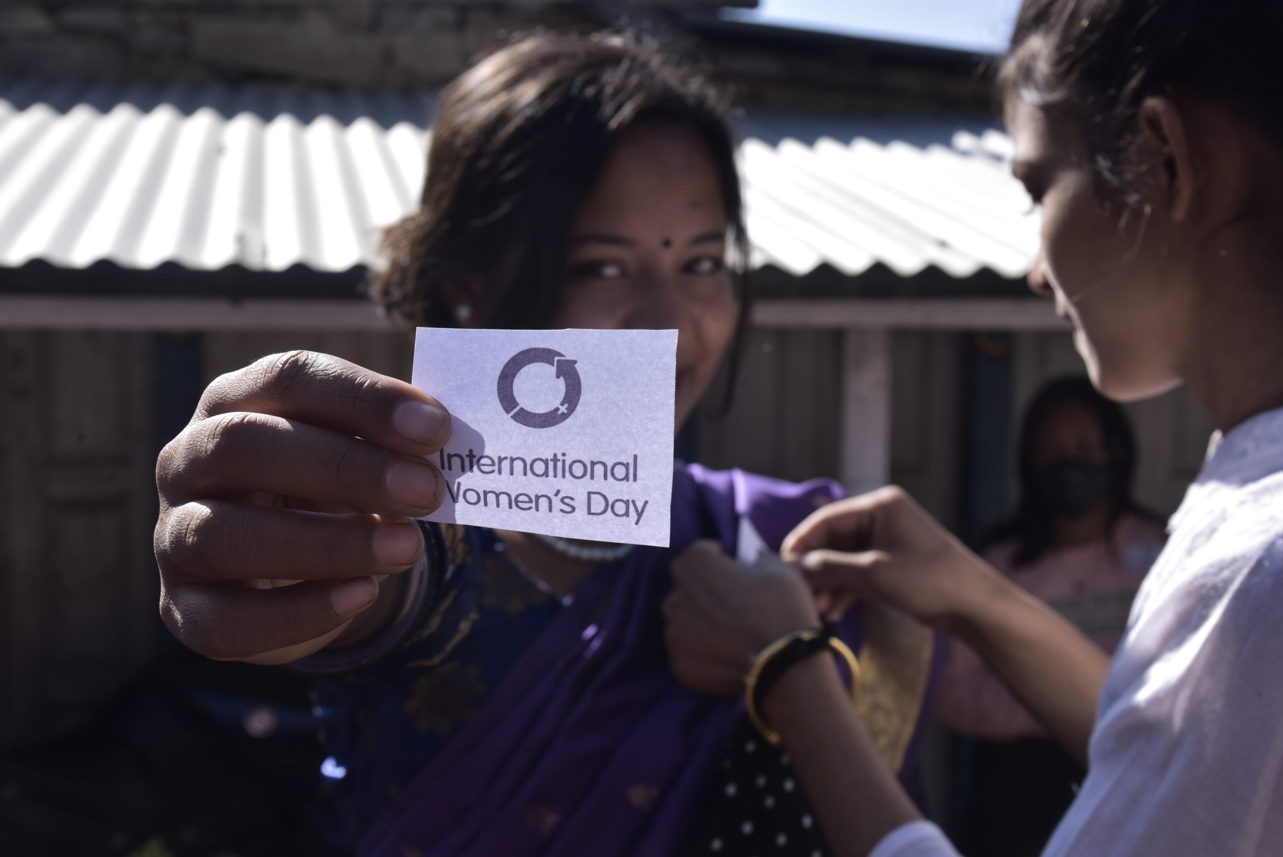 Sanjita showing the badge of International Women_s day