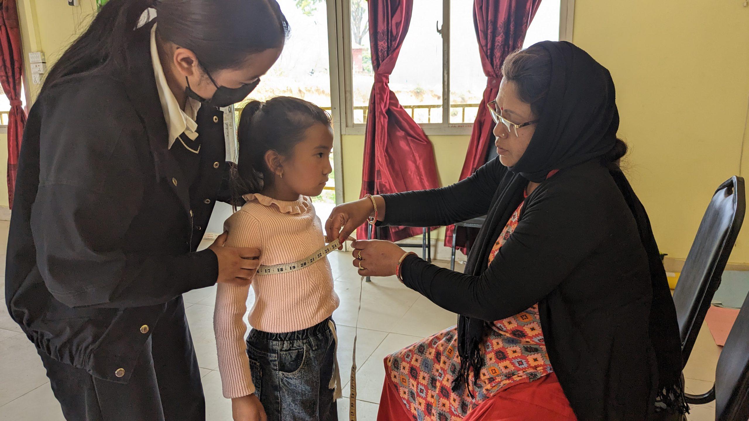 Member of Yog Mahila Samuha measured the dress of the bahini sneha_