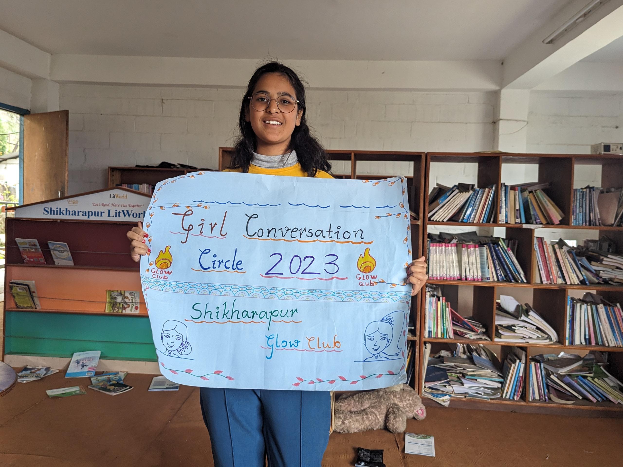 Samjhana Girl Advocacy Representative with banner of Girl Led Conversation Circle
