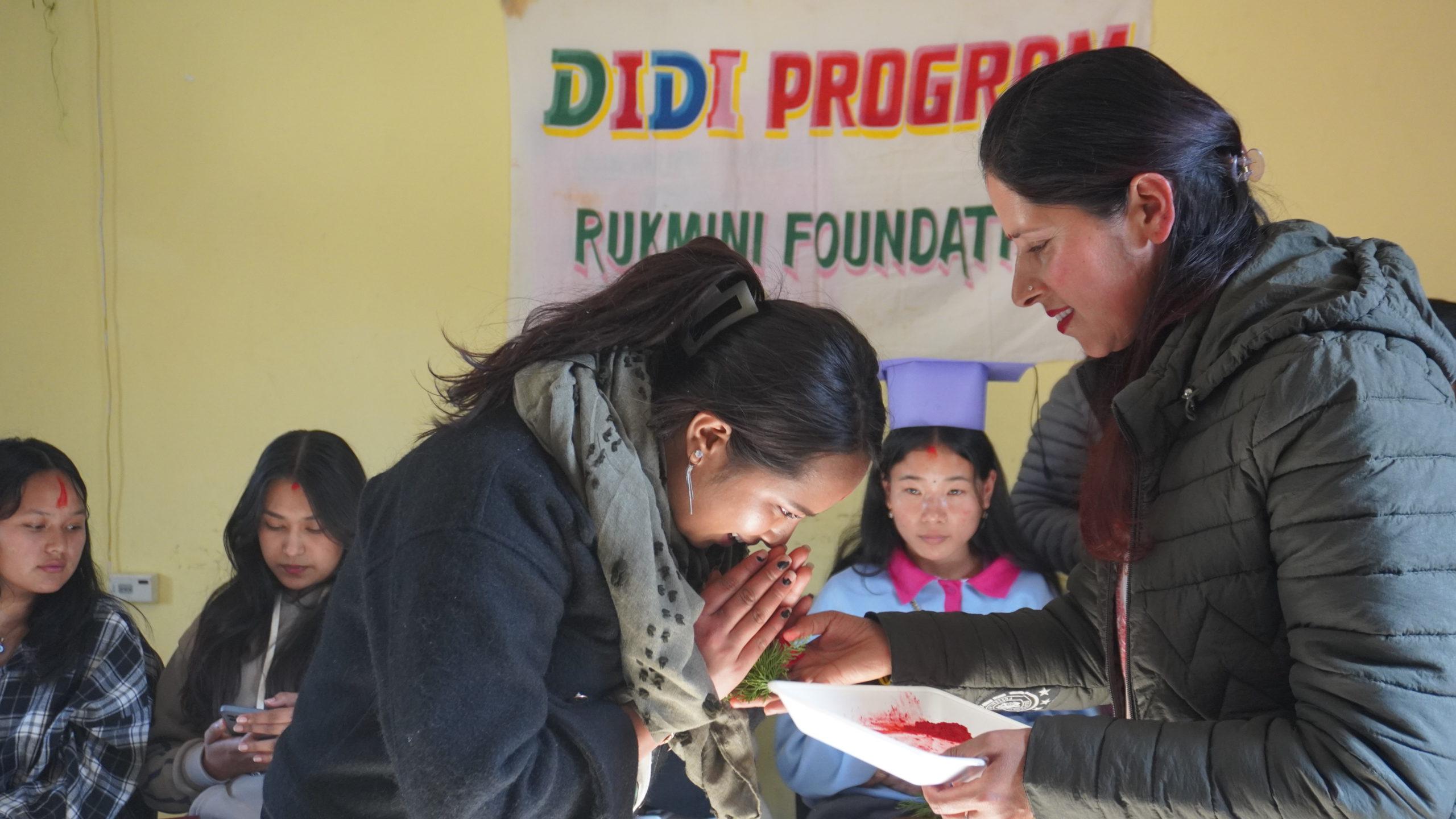 Salina Ghatani (RF Graduate Bahini receiving bunches of flower from Usha Didi