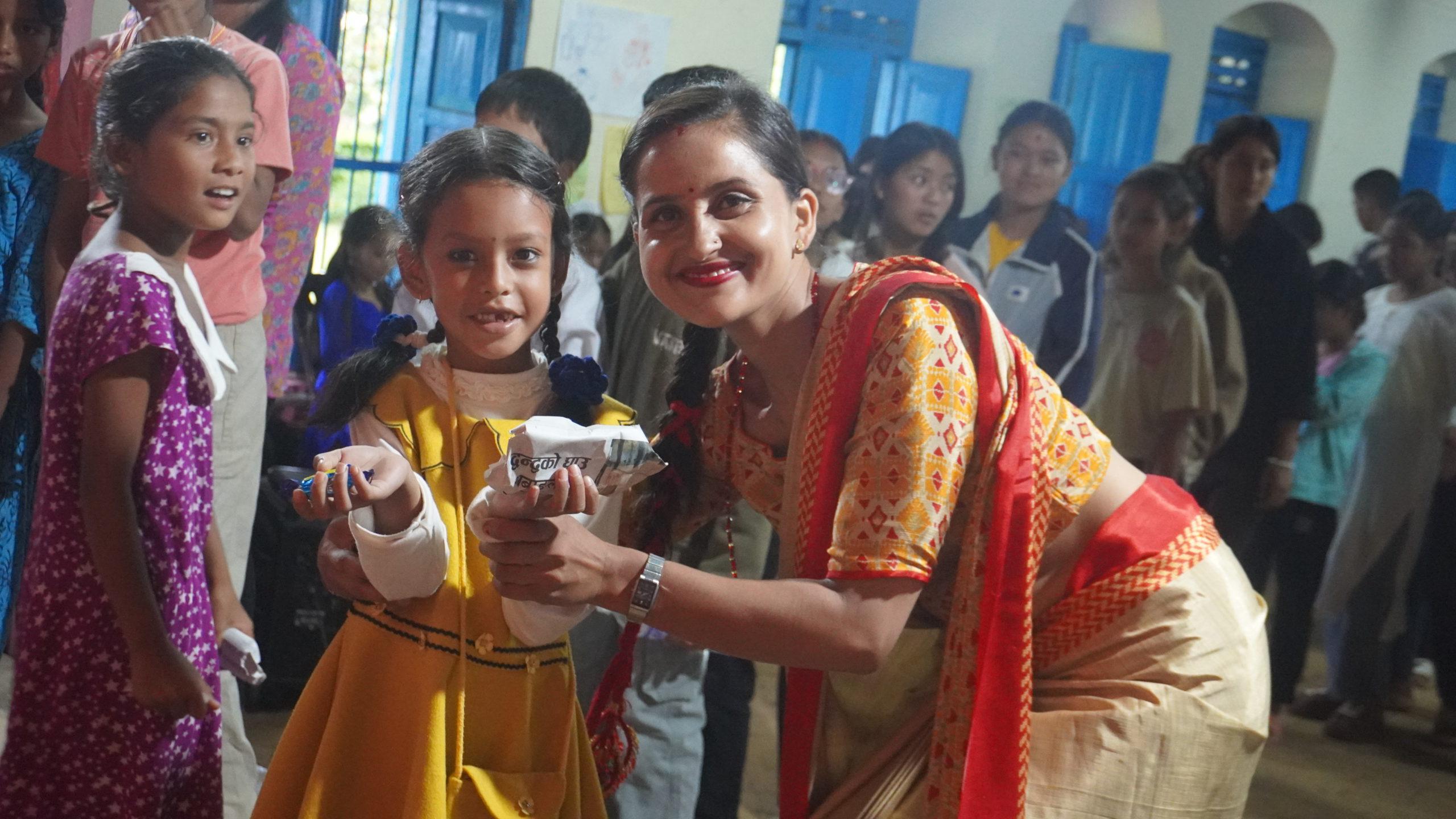 Sanvi bahini recieving children_s day gift from Roshana didi_