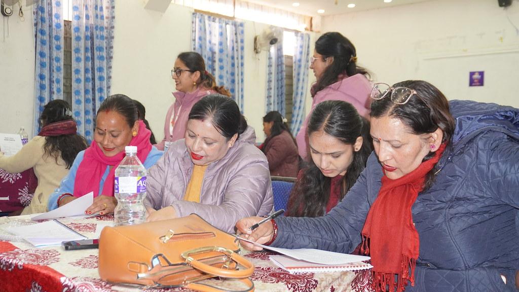 Teachers completing a pre-test before training