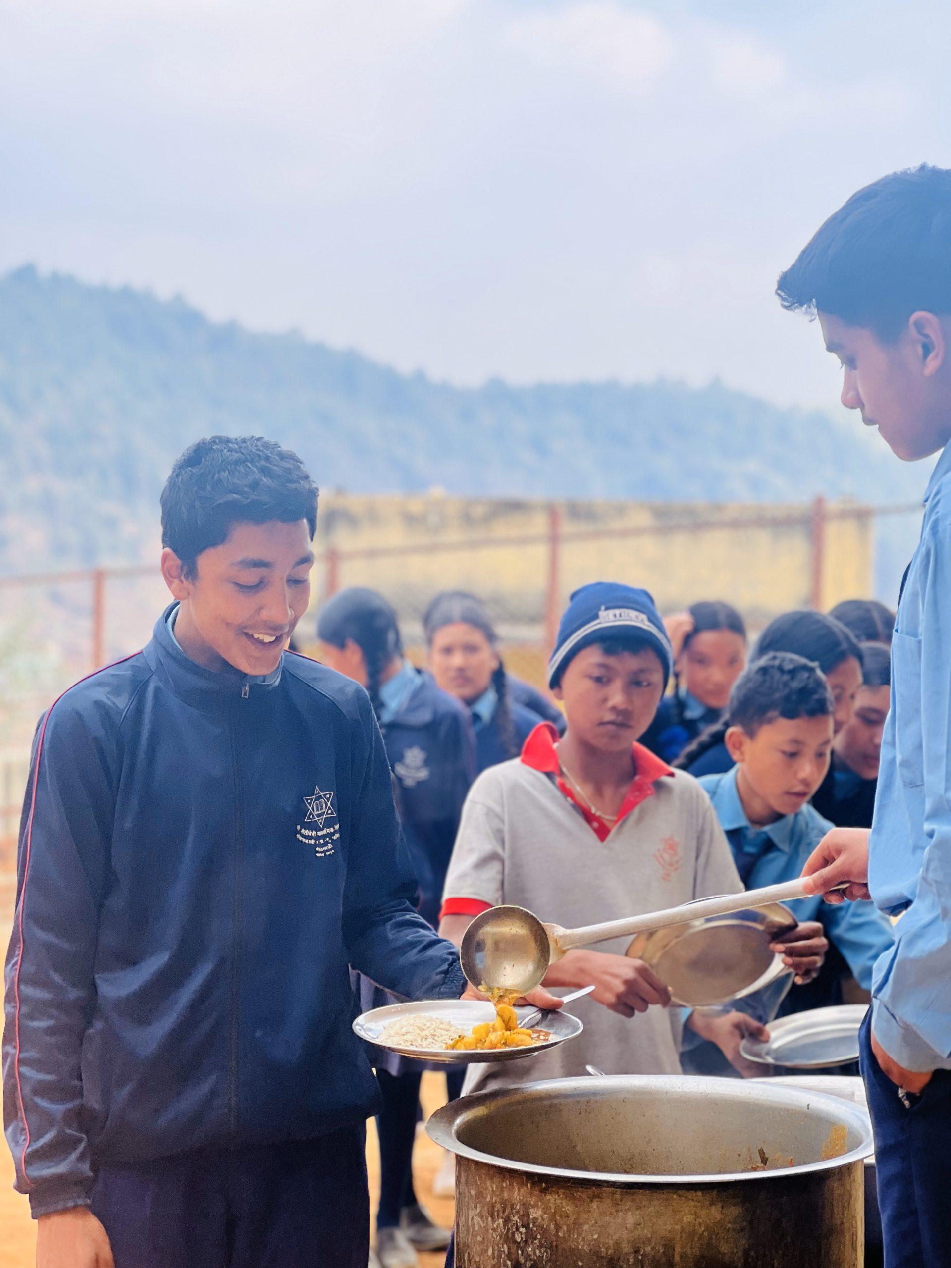 Student receiving food with smile