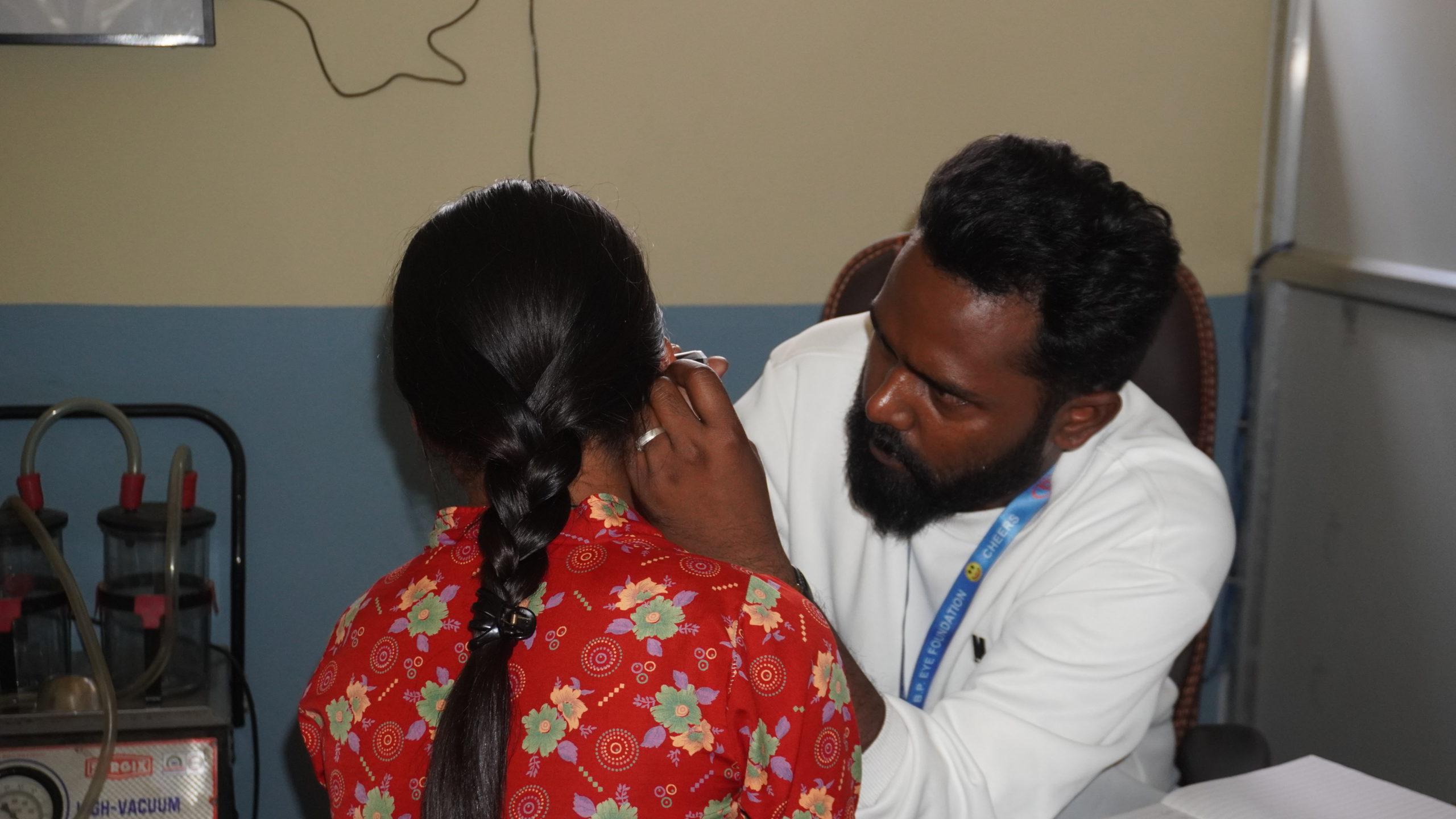 Doctor checking the ear of bahini Harikala_