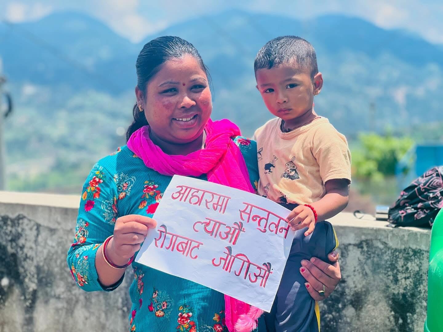 Student and parent holding pamphlets of the nutrition program