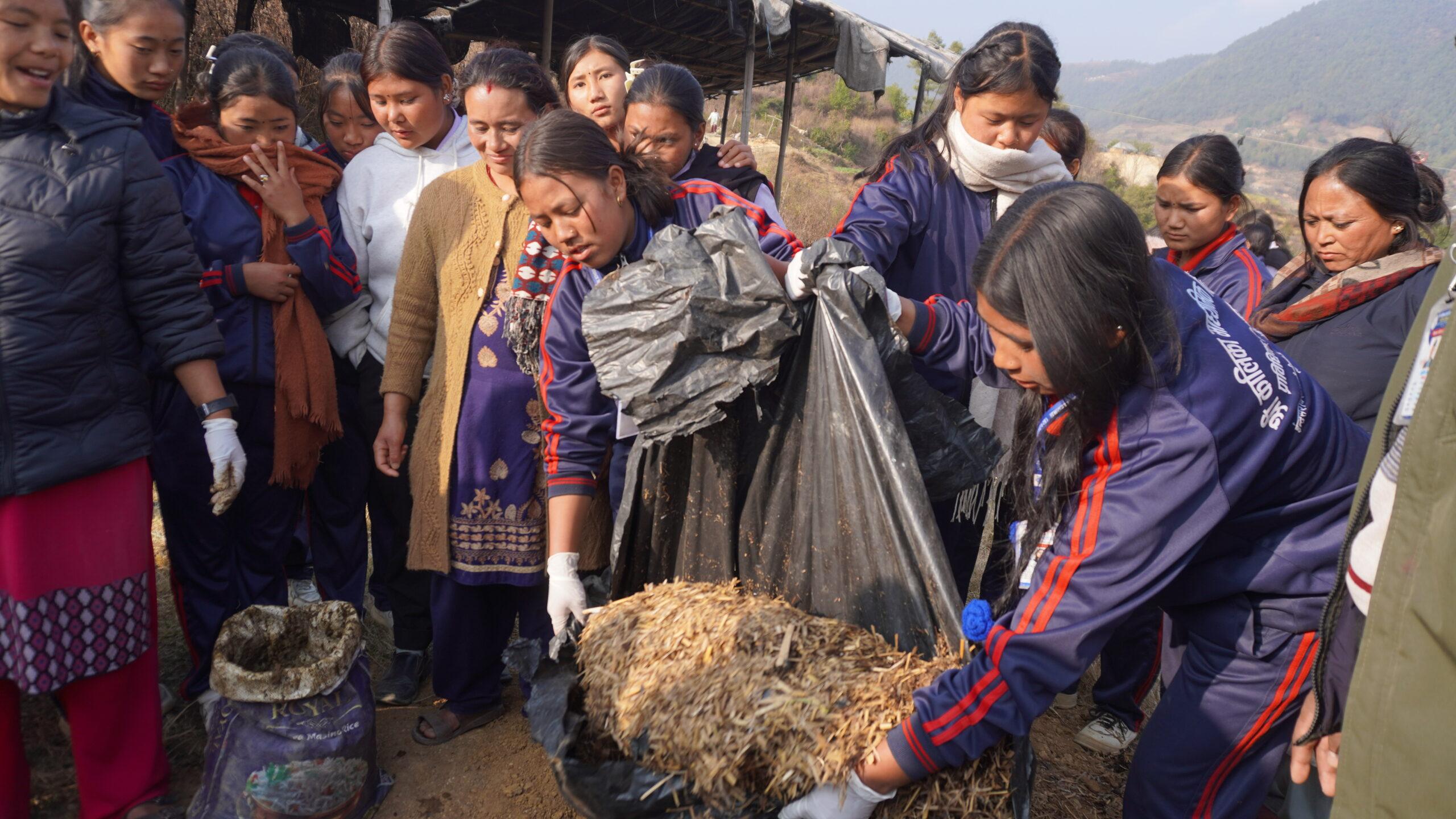 Students assisting by bringing straw (paral) for the compost preparation_