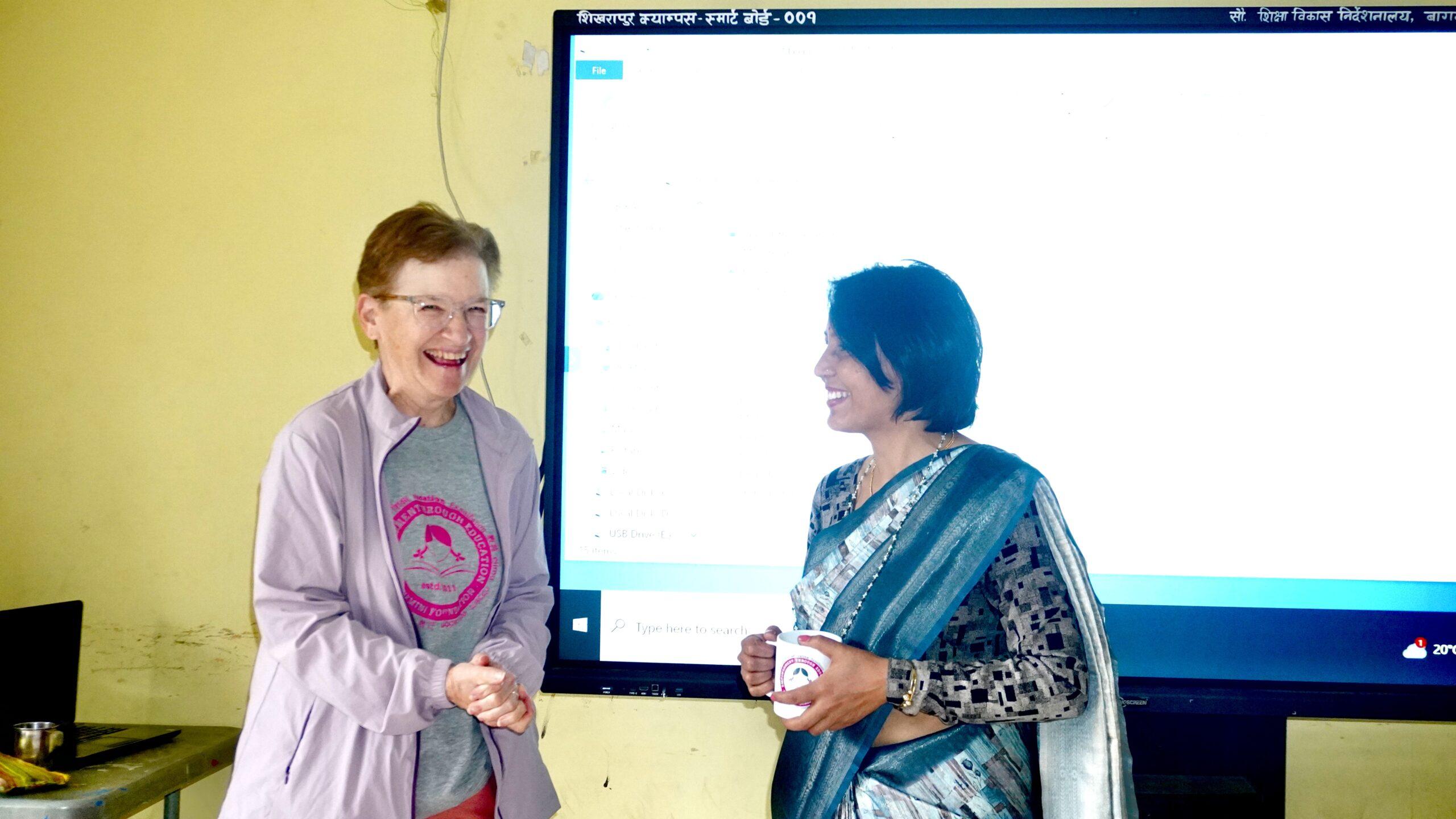 Tina (left) handing over a token of love a cup with the Rukmini logo to Pabitra didi