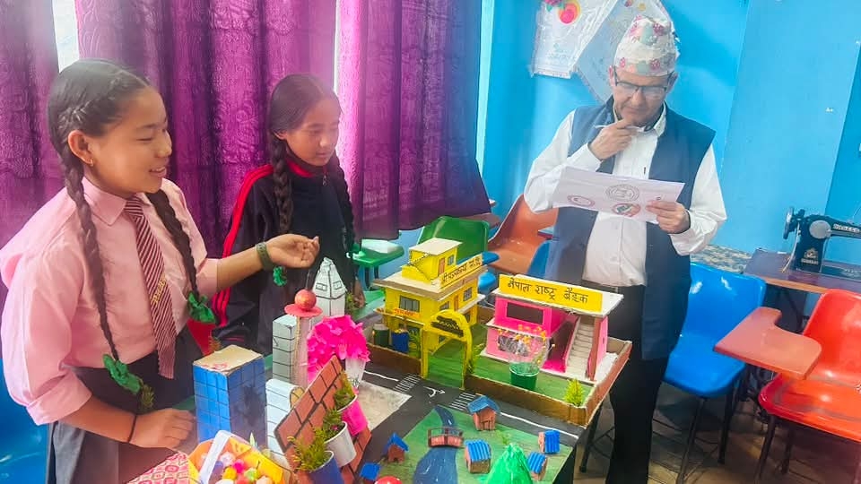 Bhumika from Panchakanya presenting a model of managed urbanization, while Laxman Dahal evaluates the presentation