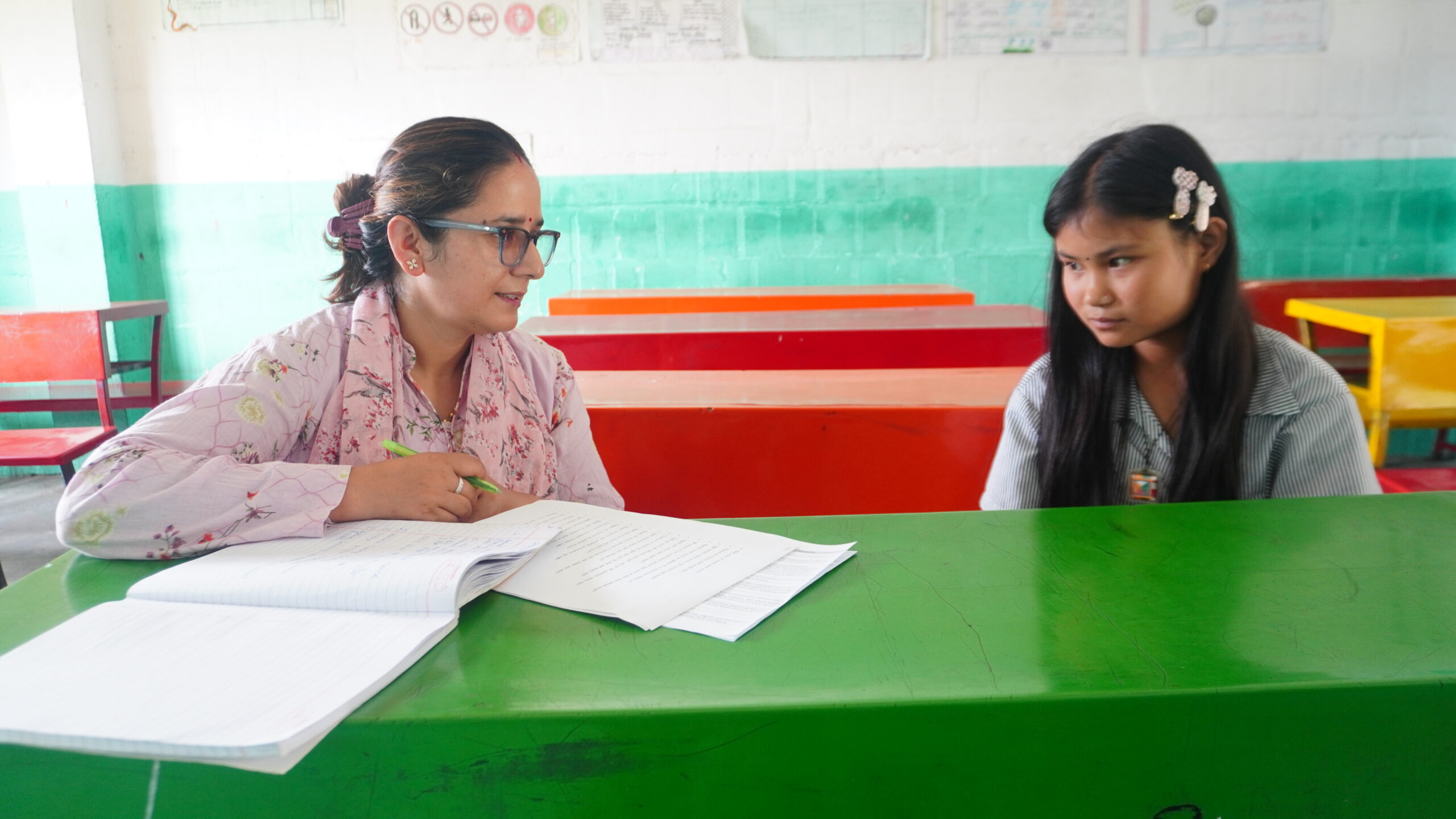 Dipa Didi having a conversation with Rashmi Bahini about her studies during an individual Didi mentoring session.