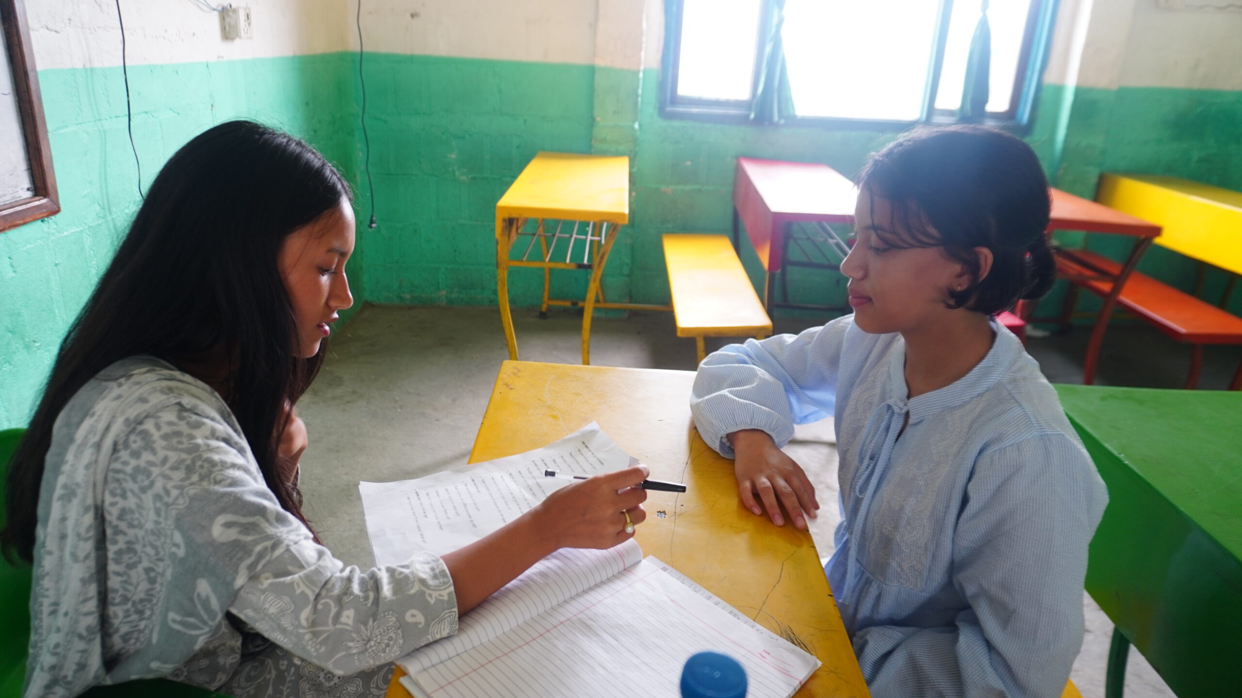 Yojana Didi having a conversation with Kavya Bahini about her studies.